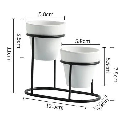 a couple of white pots sitting on top of a metal stand