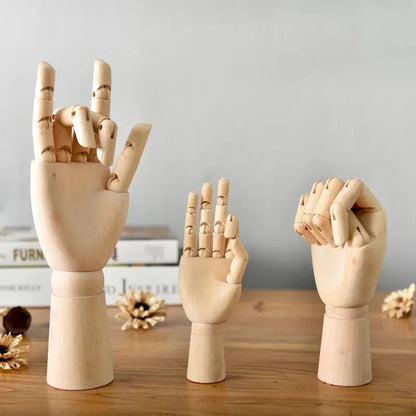 a wooden sculpture of a hand making a gesture