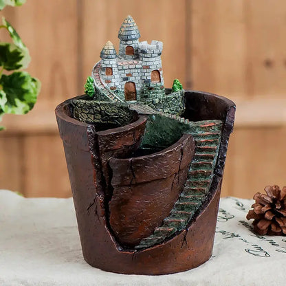 a potted plant with a castle in it