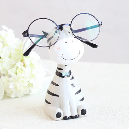 a zebra figurine with glasses on top of it