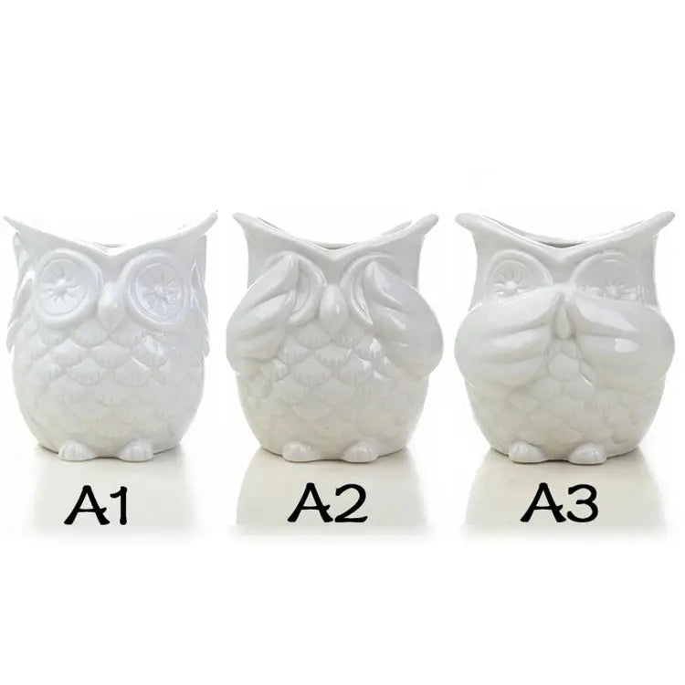 three white ceramic owls sitting next to each other