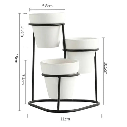 three white pots on a black stand with measurements
