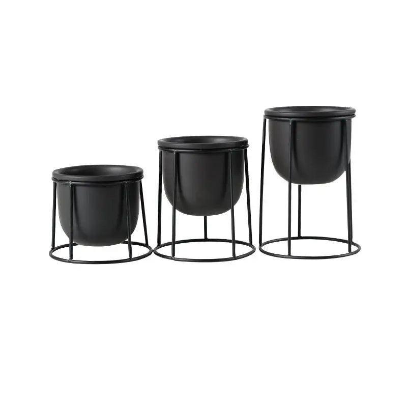 three black planters sitting next to each other