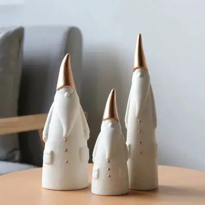 three ceramic christmas trees sitting on a table
