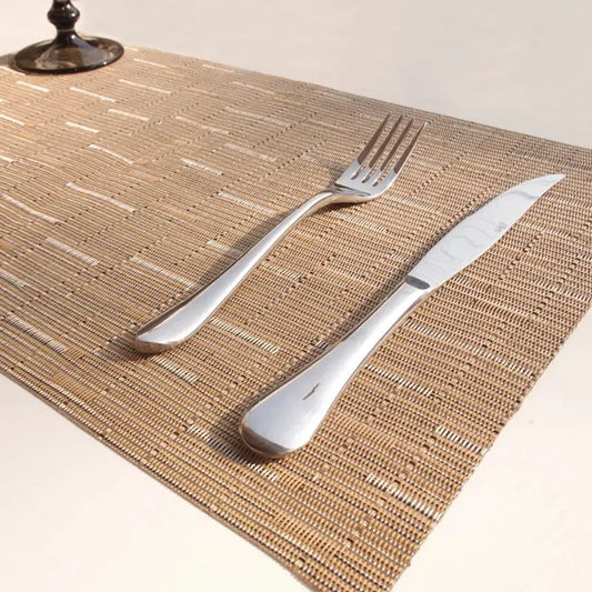 a fork and knife sitting on top of a place mat