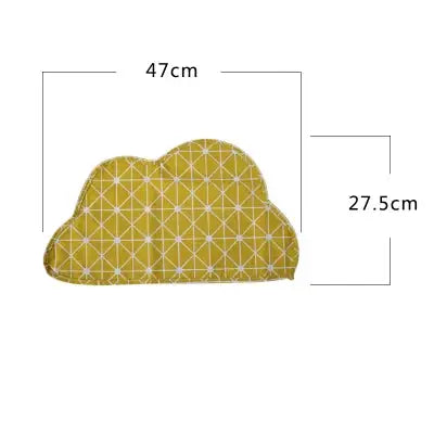a yellow cloud shaped pillow with a pattern on it