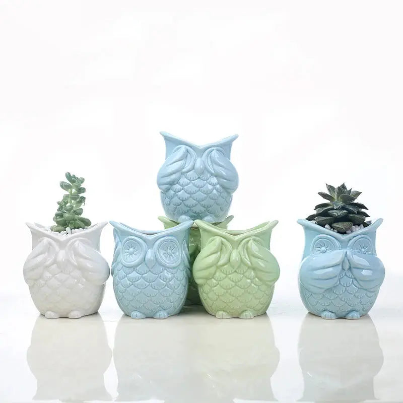 a group of ceramic owls sitting next to each other