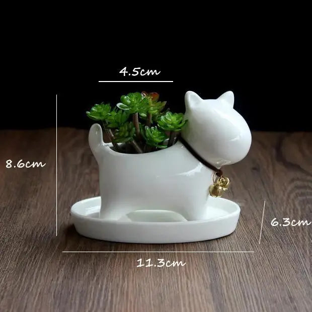 a white cat planter with a plant in it