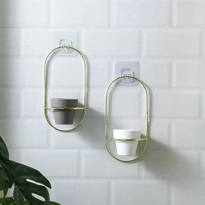 a couple of metal wall mounted cups on a wall