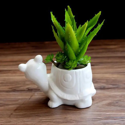 a white ceramic planter with a plant inside of it