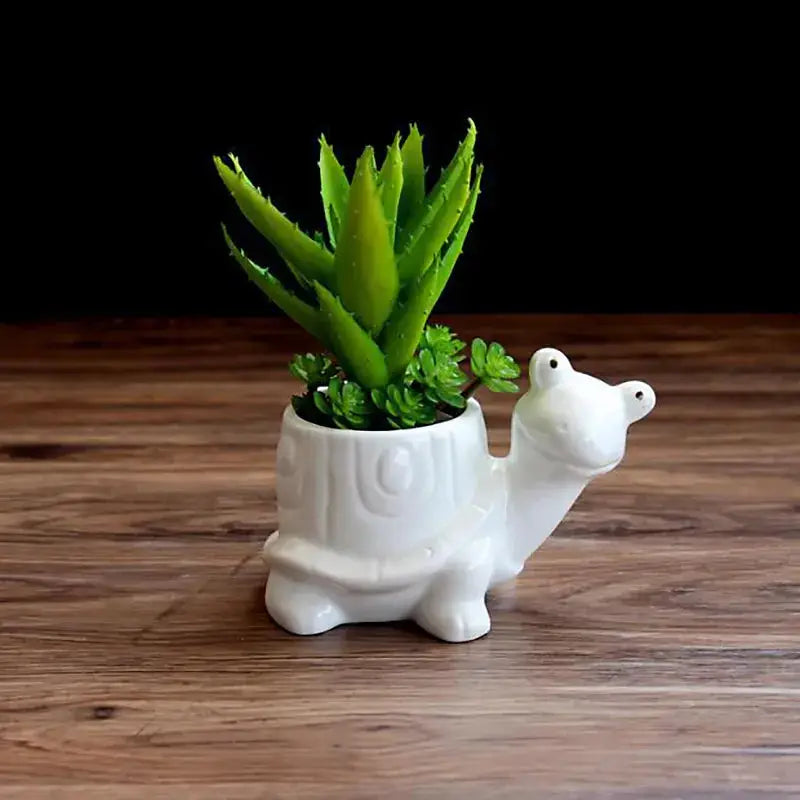 a white ceramic planter with a plant in it