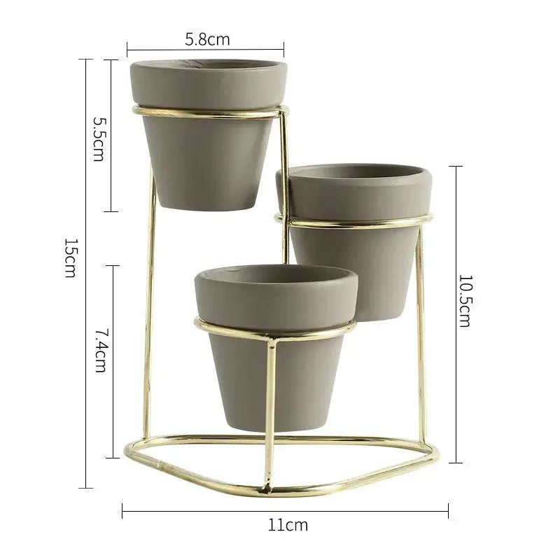 a set of three planters sitting on top of a metal stand