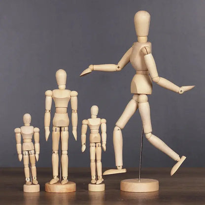 a group of wooden mannequins standing next to each other