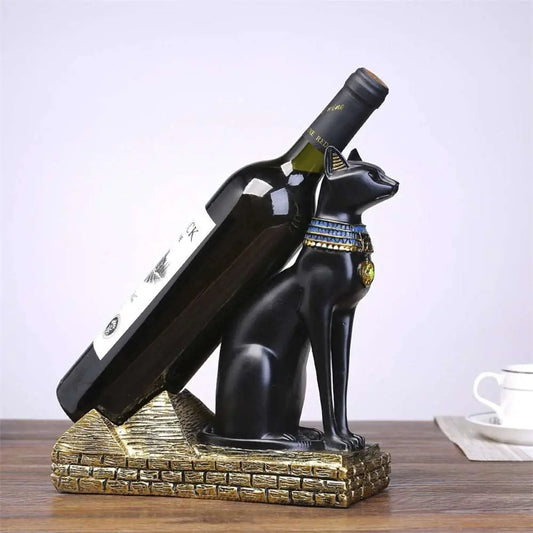 a bottle of wine and a statue of an egyptian cat