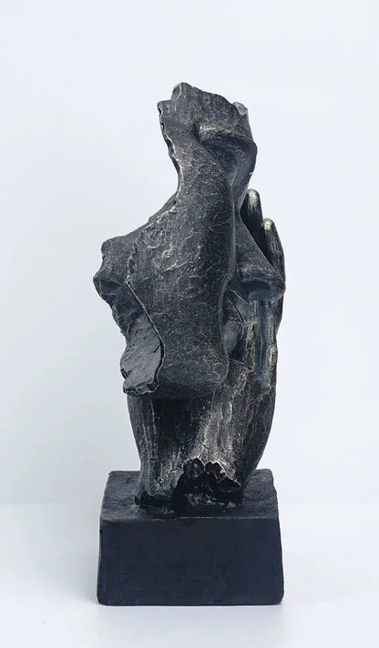 a sculpture of a woman's torso on a black base