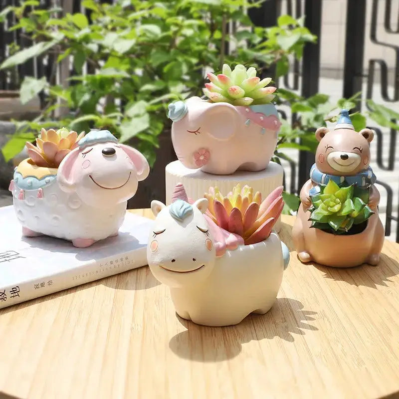 three ceramic animals sitting on top of a wooden table
