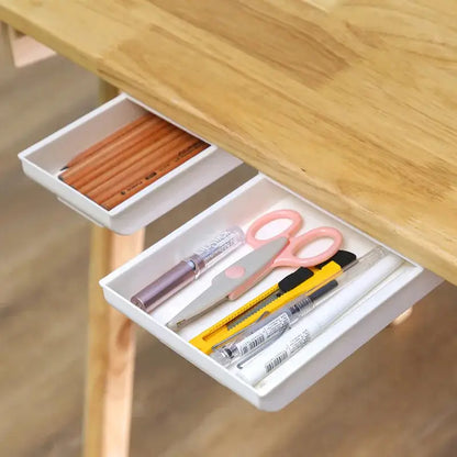 a drawer with a pair of scissors and pencils