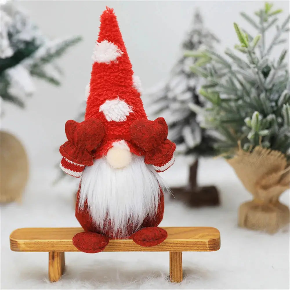 a red and white knitted gnome sitting on a bench