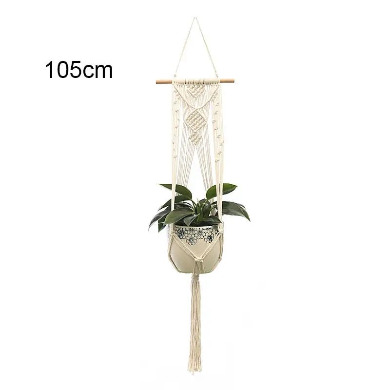 a macrame hanging planter with a plant in it