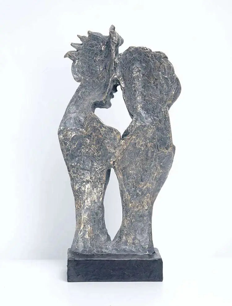a sculpture of two people holding each other