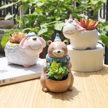 a couple of ceramic animals sitting on top of a wooden table