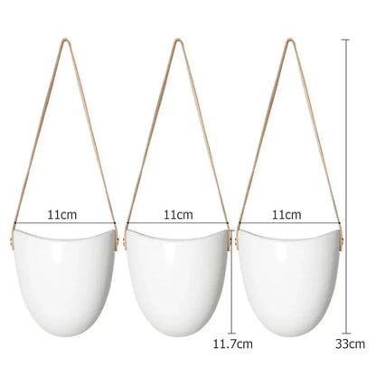 three white hanging planters with wooden handles