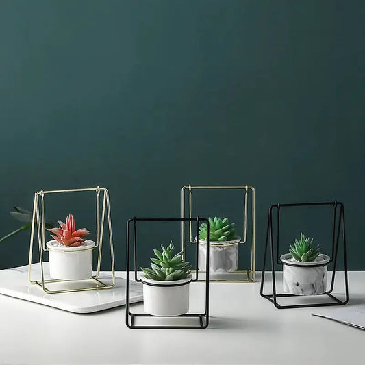 a group of three planters sitting on top of a white table
