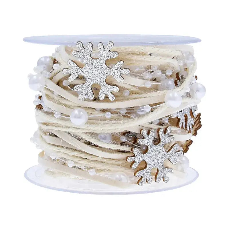 a spool of white string with snowflakes on it
