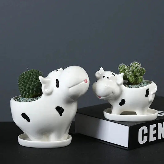 a couple of white ceramic animals sitting next to each other