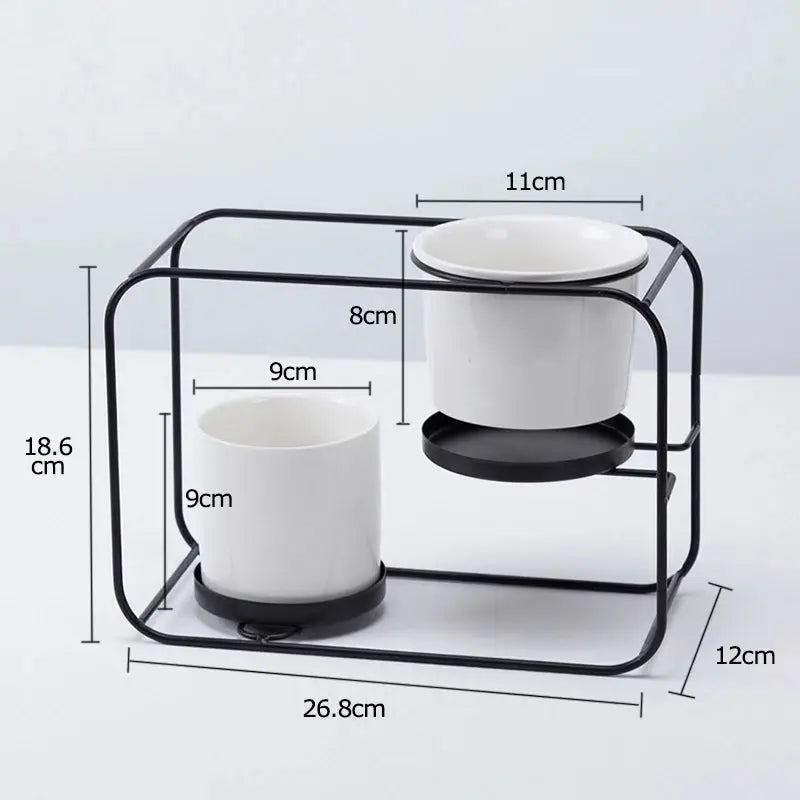 a couple of cups sitting on top of a metal stand