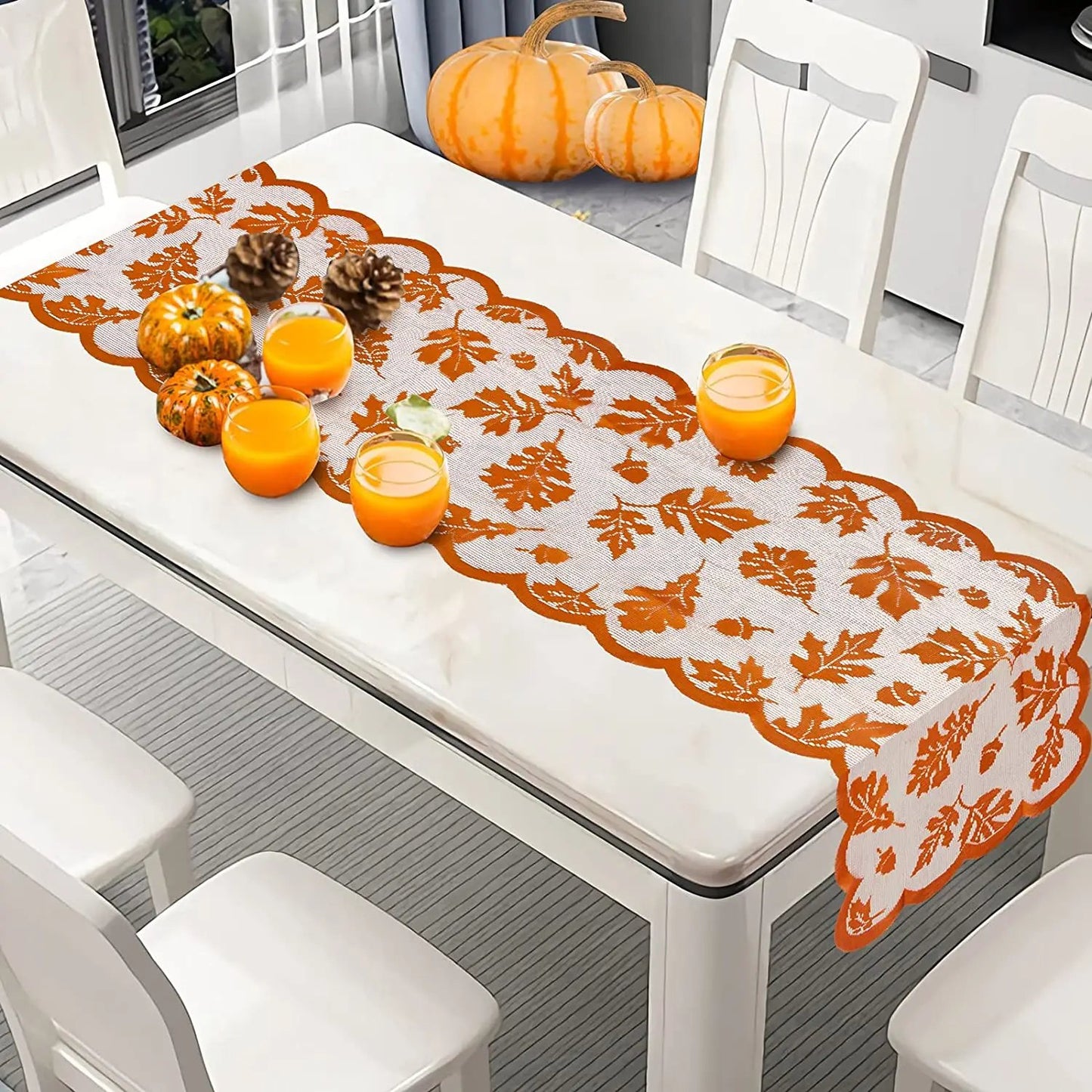 a white table topped with oranges and candles
