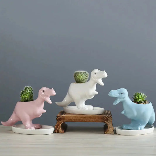 a group of three ceramic dinosaurs sitting next to each other