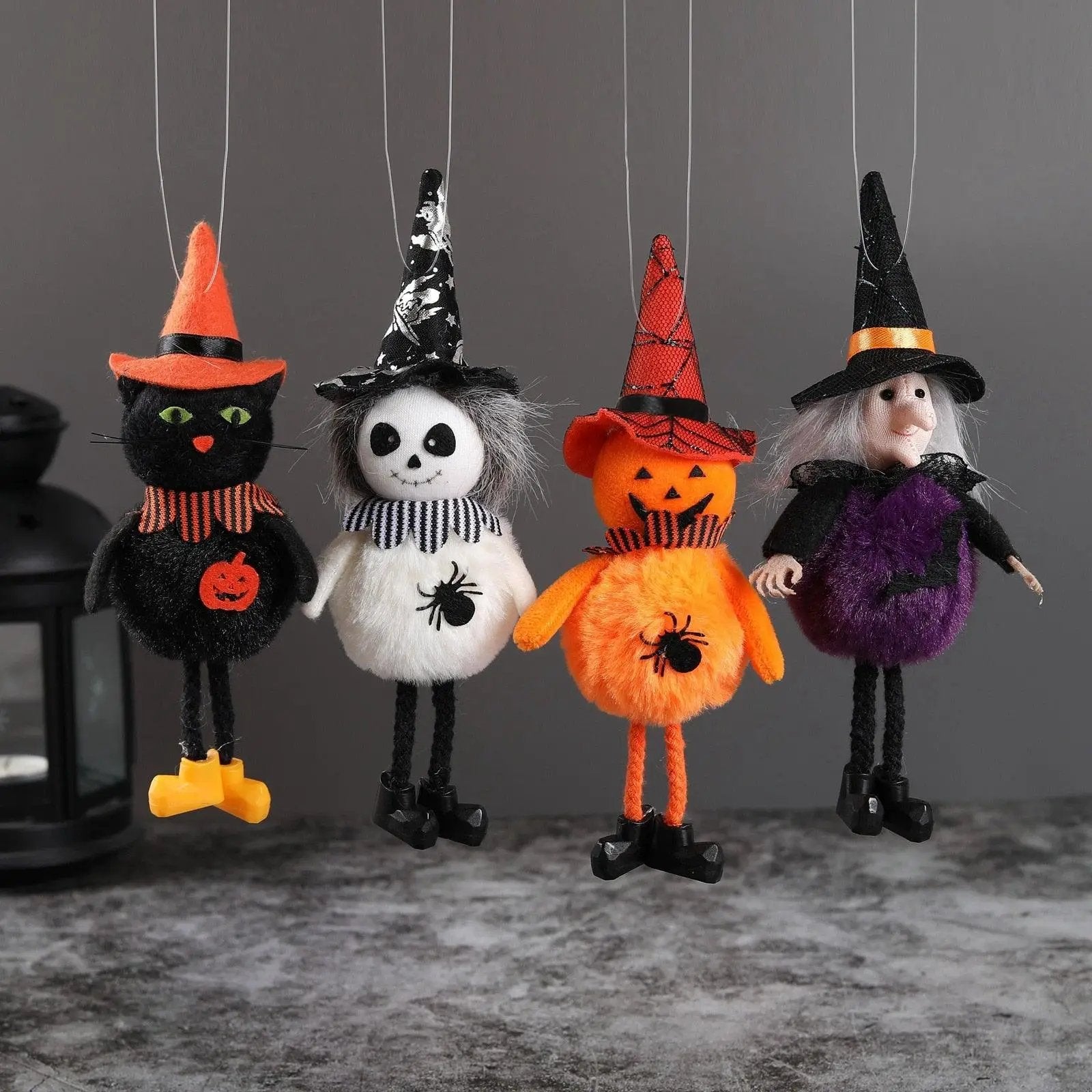 a group of halloween decorations hanging from strings