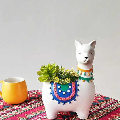 a ceramic cat with a potted plant on top of it