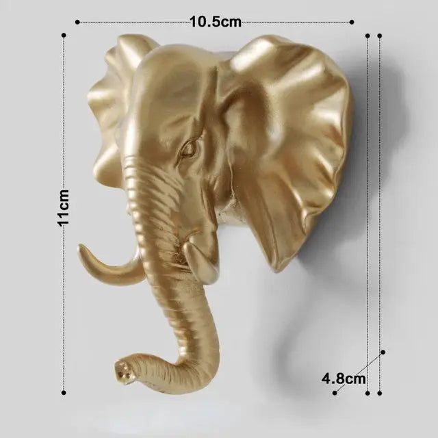 a gold elephant head mounted on a wall