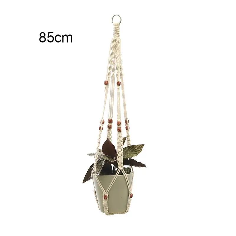 a hanging planter with beads and leaves