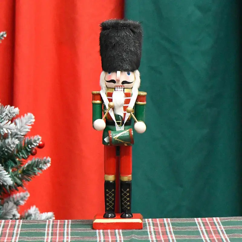 a nutcracker figurine sitting on a table next to a christmas tree
