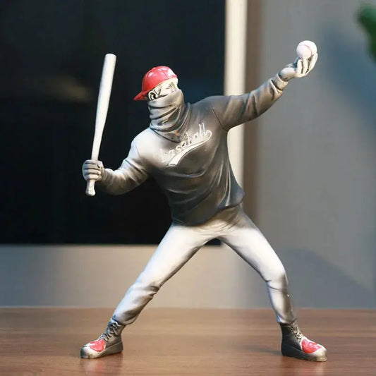 a statue of a baseball player holding a bat