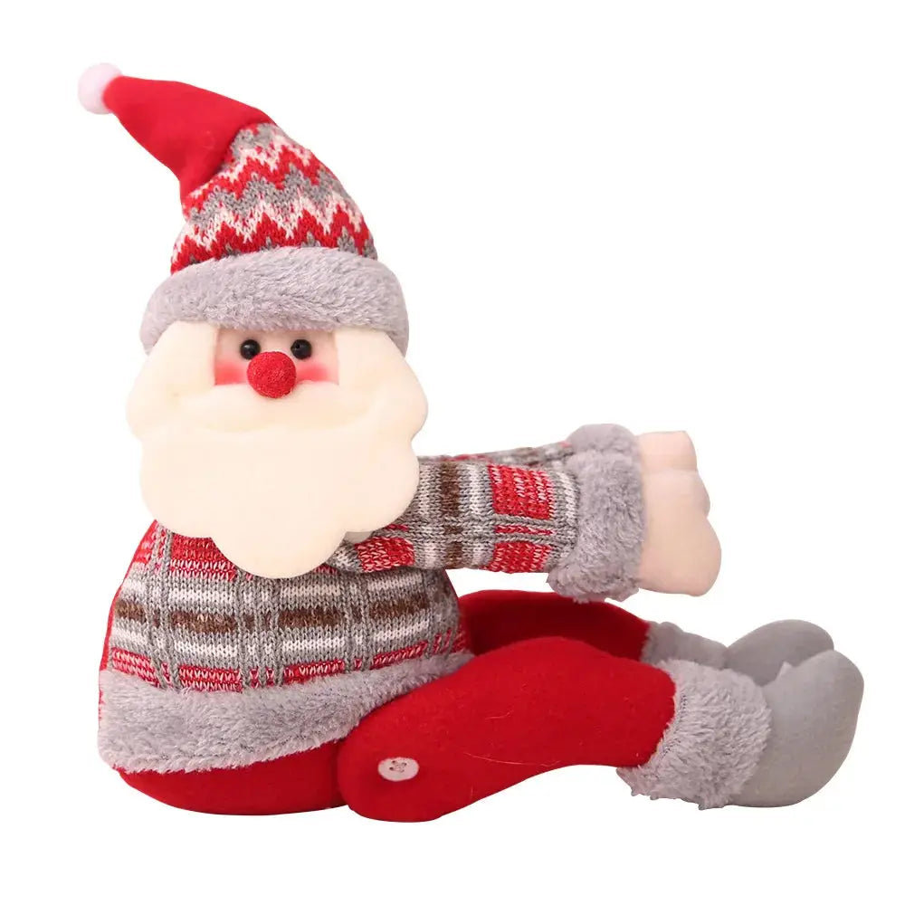 a stuffed santa clause sitting on the ground