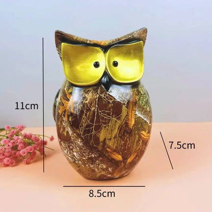 a glass owl figurine sitting on top of a table