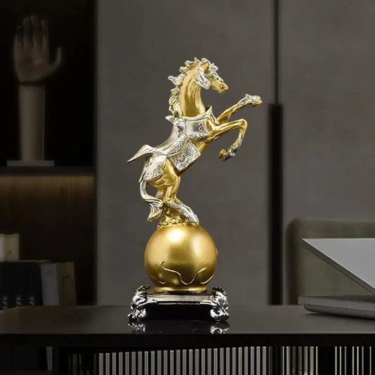 a golden statue of a horse on top of a table