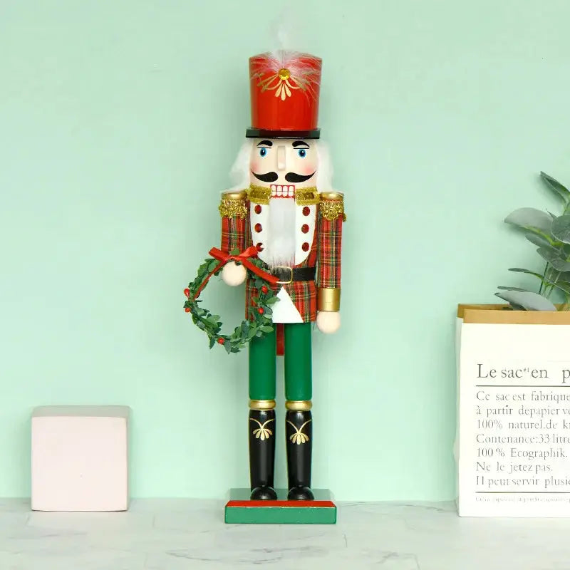 a nutcracker with a wreath on top of it
