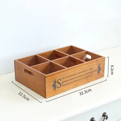 a wooden box with compartments on top of a table
