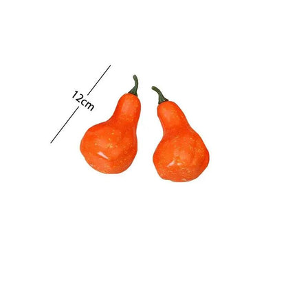 a couple of orange peppers sitting on top of a white table