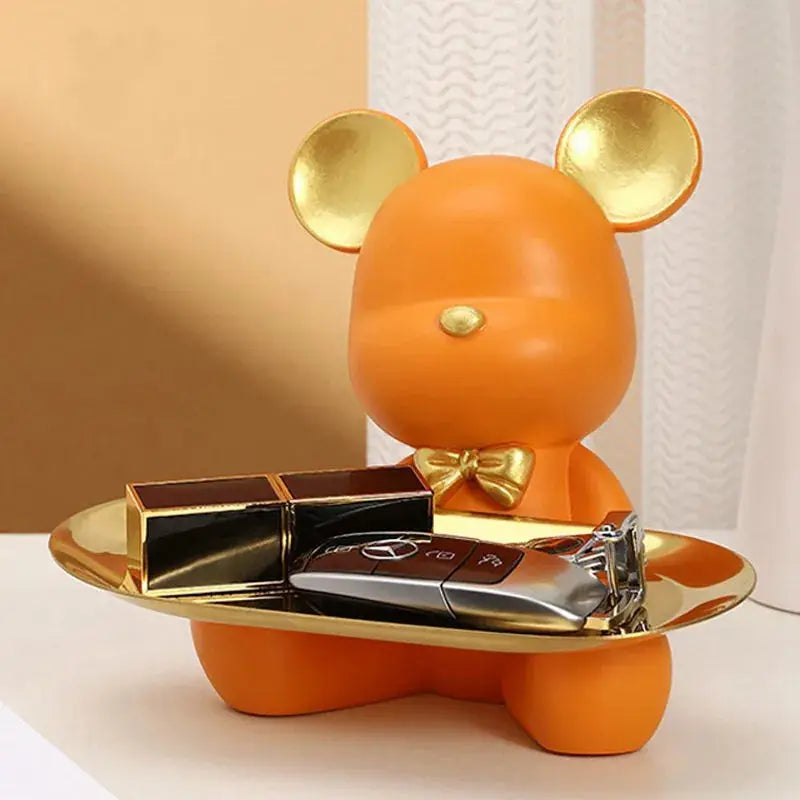 a toy mouse holding a tray of chocolates