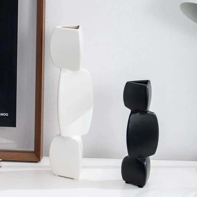 a black and white sculpture next to a framed picture