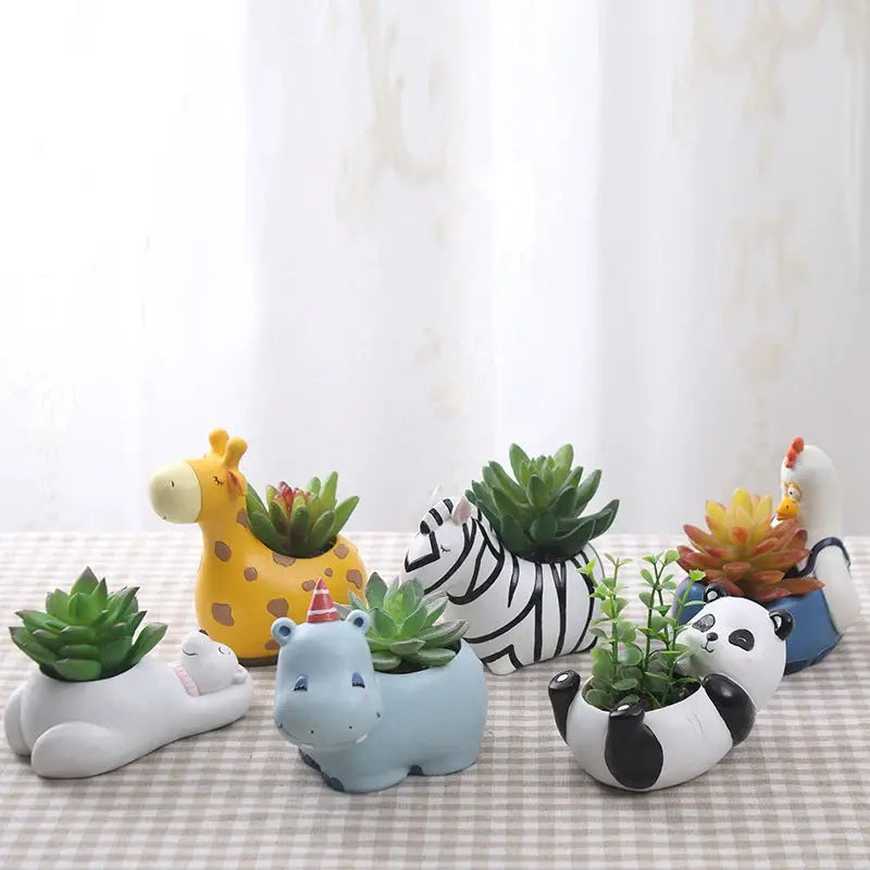 a group of ceramic animal planters sitting on top of a table