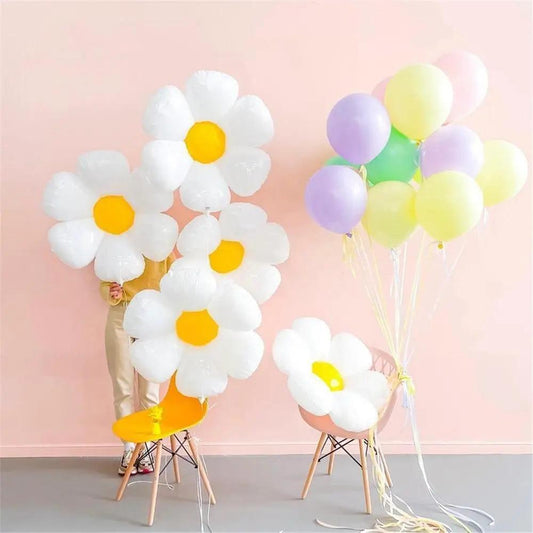 a person sitting on a chair with a bunch of balloons