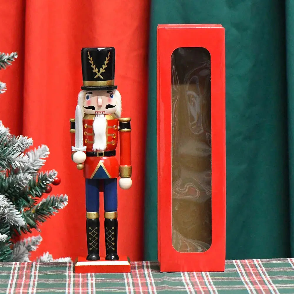 a nutcracker is in a red box next to a christmas tree