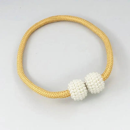 a yellow and white bracelet with two beads